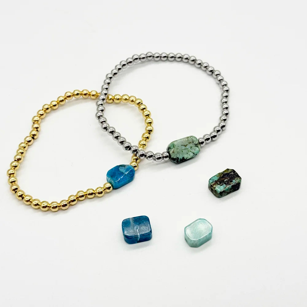 Pulsera bolitas doradas con una Piedra