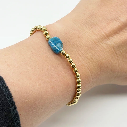 Pulsera bolitas doradas con una Piedra