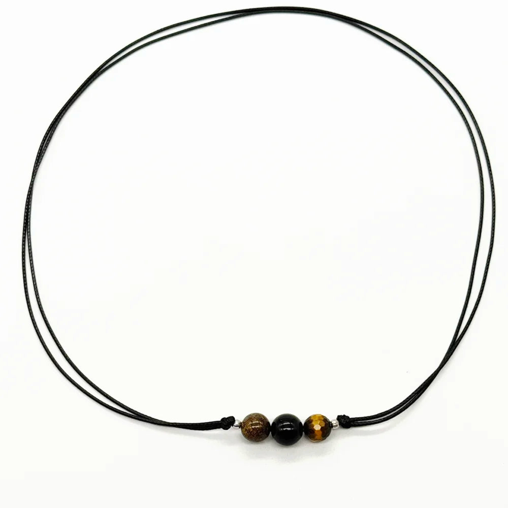 Collar de protección unisex en cordón negro con ojo de tigre, turmalina negra y broncita