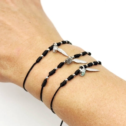 Pulsera de hilo negro con pluma y mineral natural